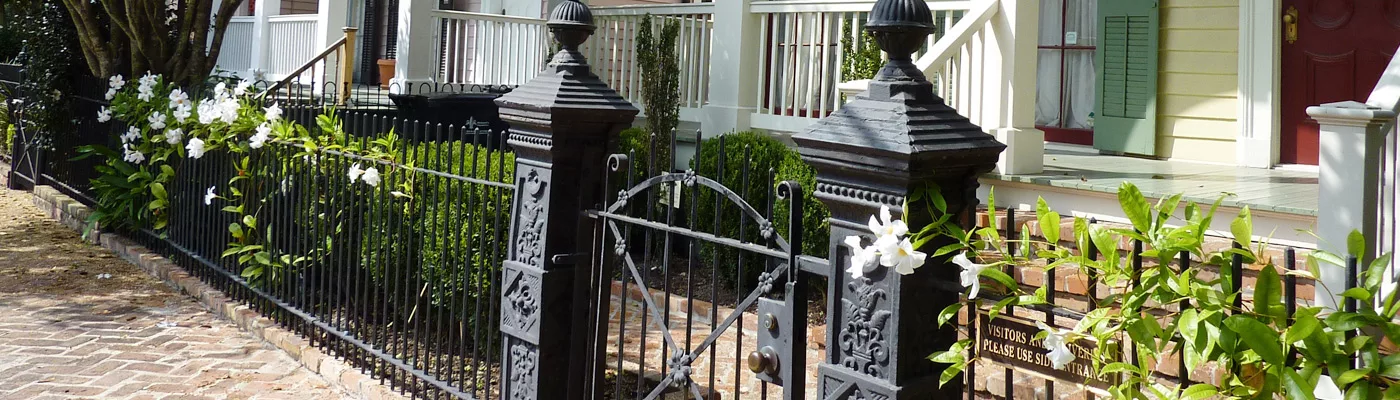 A Garden District wrought iron fence gate
